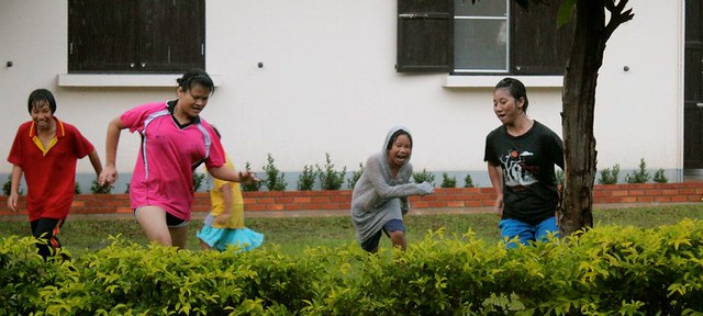 Children Playing Football In Rain