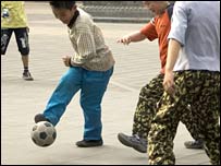 Children Playing Football In The Street